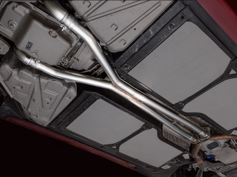 AWE Tuning 05-07 Chevrolet Corvette C6 6.0L X-Pipe, stainless steel exhaust component with polished finish, installed on vehicle.