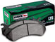 Hawk Performance OE rear brake pads installed on a Silverado/Sierra 1500 LTS truck, showing the brake pad design and branding.