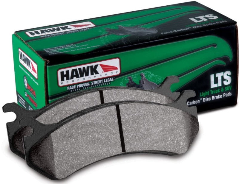 Hawk Performance OE rear brake pads installed on a Silverado/Sierra 1500 LTS truck, showing the brake pad design and branding.