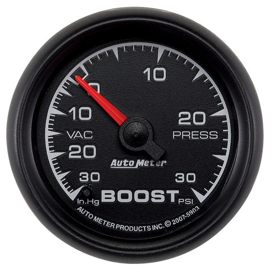 AutoMeter ES 52mm Boost and Vacuum Gauge showing dial with boost and vacuum readings in a car dashboard.