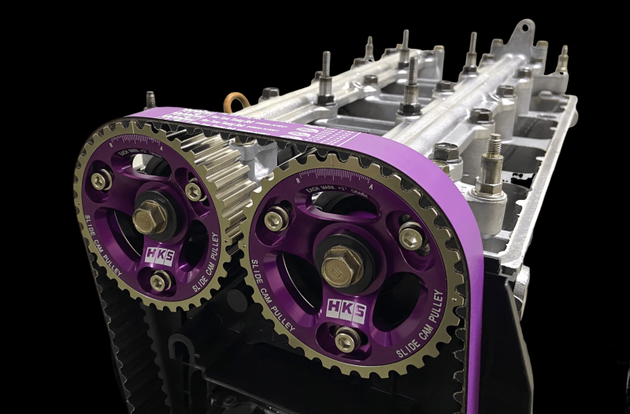 HKS slide cam pulley for B16 and B18C engine, shown in black with metal mounting components on a neutral background.