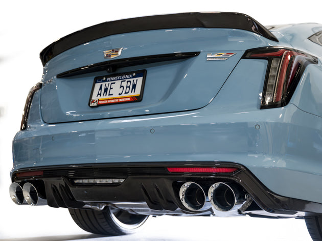 AWE Tuning Cadillac CT5-V Blackwing catback exhaust with chrome silver tips, showcasing sleek black muffler and dual exhaust outlets.