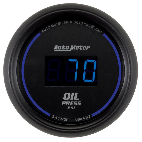 AutoMeter Cobalt digital 52.4mm black oil pressure gauge showing 0-100 psi reading on a car dashboard