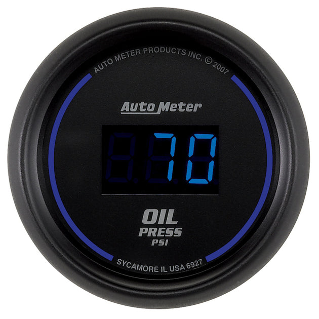 AutoMeter Cobalt digital 52.4mm black oil pressure gauge showing 0-100 psi reading on a car dashboard