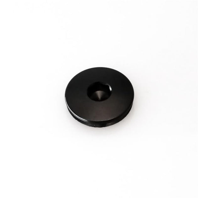 Black Turbosmart BOV Kompact Port Blanking Plug for blow-off valve accessories, designed for precise engine boost control.