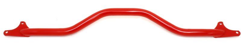 Red BMR Suspension GTO front strut tower brace installed in a vehicle, enhancing chassis rigidity and handling.