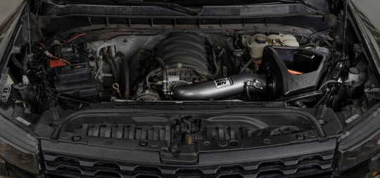 K&N Engineering Chevy/GMC 1500 V8 6.2L NextGen aluminum cold air intake installed in engine bay, showcasing sleek metal tubing and filter.