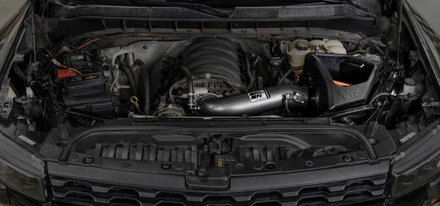 K&N Engineering Chevy/GMC 1500 V8 6.2L NextGen aluminum cold air intake installed in engine bay, showcasing sleek metal tubing and filter.