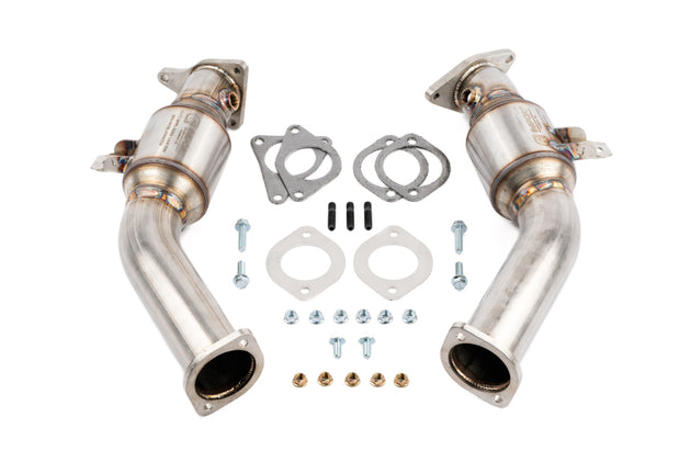 AMS Performance VR30DDTT street lower downpipes with GESI catalytic converter installed, showcasing the sleek, polished metal pipes.