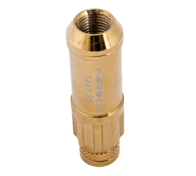 NRG 700 Series M12 x 1.25 steel lug nut set with dust cap, locks, and socket in chrome gold finish, shown with the complete set.