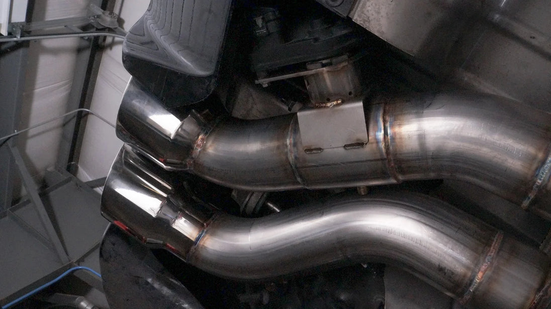 Stainless Works 3-inch dual turbo cat-back exhaust system with mufflers for CTSV, displayed on a vehicle.
