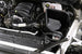 K&N Engineering cold air intake kit installed in a 2019 Chevrolet Silverado 1500 5.3L V8, featuring black performance air filter and intake tube