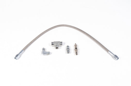 Radium Engineering fuel pressure test kit fittings with metal connectors and hoses for automotive fuel system testing.