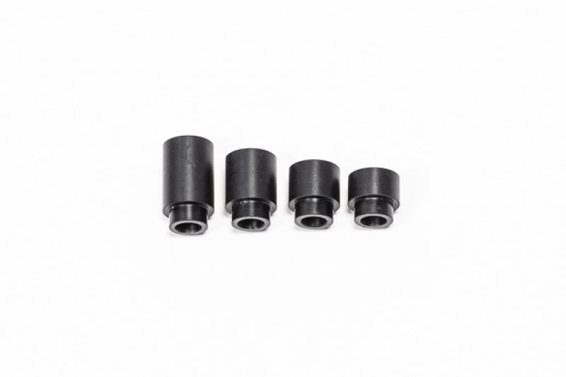 Radium Engineering 27mm insulating spacer for fuel rails, showing the black plastic component with precise dimensions and design features.