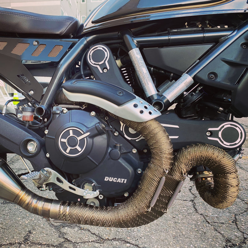 DEI Titanium exhaust wrap 2-inch by 15-foot rolled insulation material for high-temperature exhaust systems, shown coiled and ready for installation.