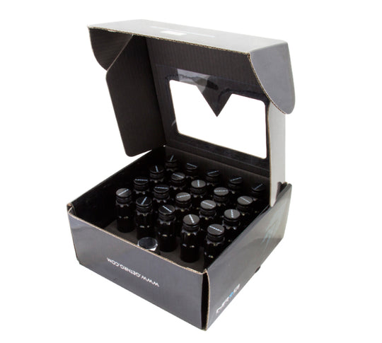 NRG 700 Series M12 x 1.5 steel lug nuts with dust cap cover set, locks, and lock socket in black, shown on a vehicle wheel.