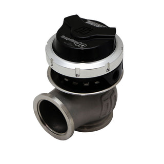 Turbosmart GenV CompGate40 black external wastegate with 7psi boost pressure setting, mounted on a vehicle engine.