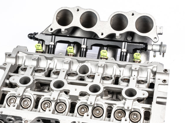 Radium Engineering Toyota 3S-GE/3S-GTE Gen 3-5 fuel rail showing metal construction, mounting points, and inlet connections.