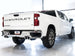 AWE Tuning 4th Gen GM 1500 6.2L catback exhaust with split rear exit and quad chrome tips, featuring bumper cutouts.