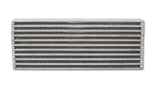 Vibrant universal oil cooler core, 4x12x2 inches, showcasing vibrant metal fins and fittings for efficient engine oil cooling.