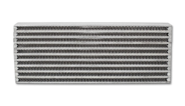 Vibrant universal oil cooler core, 4x12x2 inches, showcasing vibrant metal fins and fittings for efficient engine oil cooling.