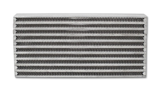 Vibrant universal oil cooler core measuring 6x10x2 inches, with metal fins and inlet/outlet ports for efficient engine cooling.