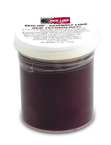 Red Line Assembly Lube 16oz bottle, a red-colored grease and lubricant for engine assembly and mechanical parts.