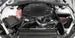 K&N Engineering silver Typhoon short ram cold air intake installed in a 2016-2017 Chevy Camaro 3.6L engine bay.