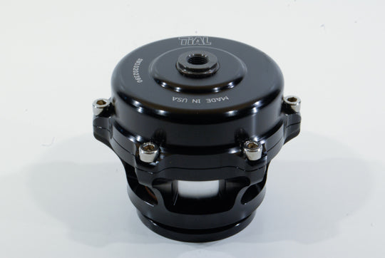 Black TiAL Sport Q BOV 12 PSI Spring blow off valve with visible metal components and black housing for automotive turbo systems.