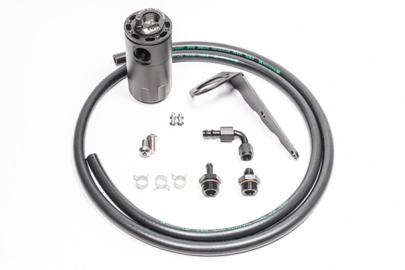 Radium Engineering GM LS engine oil catch can kit with fluid lock system, featuring black aluminum can and hoses for engine protection.