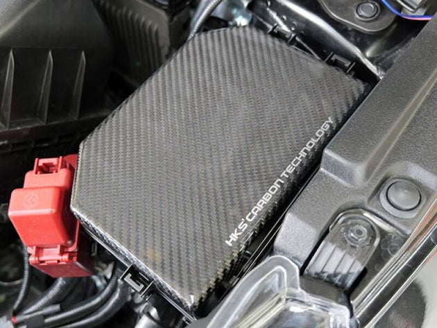 HKS 2023 Toyota GR Corolla dry carbon engine fuse box cover, lightweight and durable, with a sleek black finish.