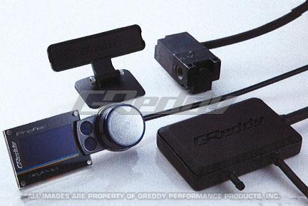 GReddy PRofec electronic boost controller with display panel and control knobs for adjusting turbo boost levels.