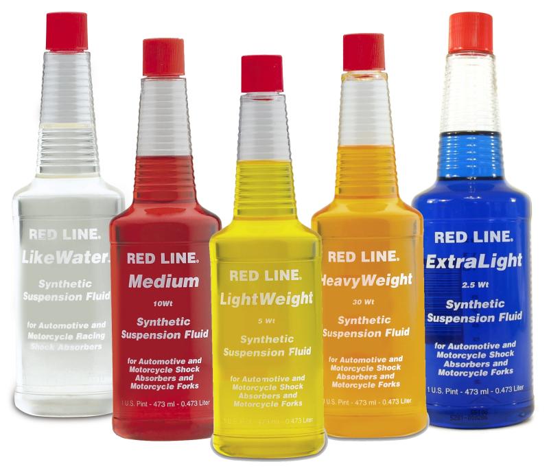Red Line HeavyWeight 30WT suspension hydraulic oil in a 16oz container, suitable for high-performance vehicle suspension systems.