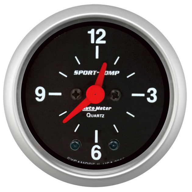 AutoMeter Sport-Comp 2-1/16 inch 12 Hour Analog Clock Gauge showing a black dial with white markings and a silver bezel.