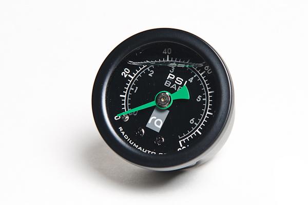 Radium Engineering fuel pressure gauge with 0-100 PSI range and 8AN adapter, showing the gauge and fittings.
