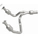 MagnaFlow direct fit catalytic converter for 2015 GMC Yukon XL V8 6.2L engine, showing the metallic converter with inlet and outlet pipes.