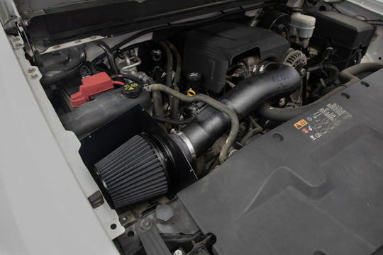 K&N Engineering performance cold air intake system for Chevrolet V8 engines 4.8L to 6.2L, shown installed in engine bay.