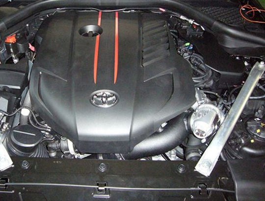 HKS SSQV IV blow off valve kit for Toyota GR Supra B58 engine, showing the sleek metal valve with hoses and mounting hardware.