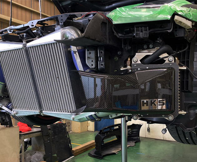 HKS DCT fluid cooler for R35 GT-R MY17-18, black oil cooler with hoses and fittings visible in the image.