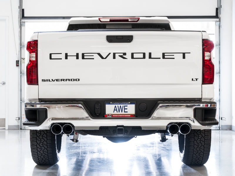 AWE Tuning 4th Gen GM 1500 6.2L catback exhaust with split rear exit and quad chrome tips, showing the polished chrome finish and bumper cutouts.