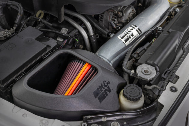 K&N Engineering aluminum cold air intake for 2012-2018 Jeep Wrangler NextGen, featuring sleek metal tubing and air filter.