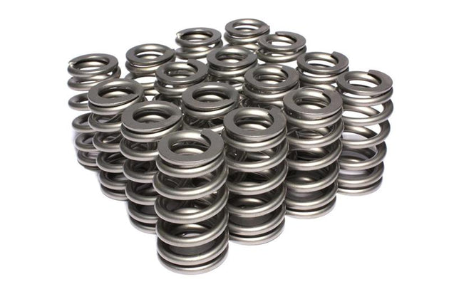 High-performance COMP Cams valve springs and retainers for engine upgrades, showing metal components with detailed machining.