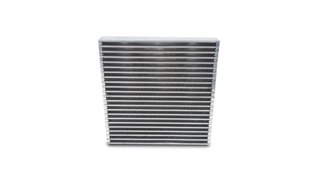Vibrant universal oil cooler core measuring 12x12x2 inches, with metal fins and inlet/outlet fittings for automotive cooling system