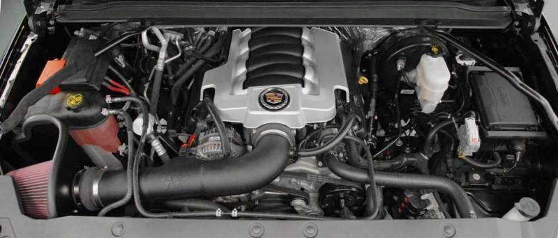 K&N 77 Series cold air intake kit installed in a Chevy Silverado or GMC Sierra 2014-2015, showing the performance air filter and intake tubing.