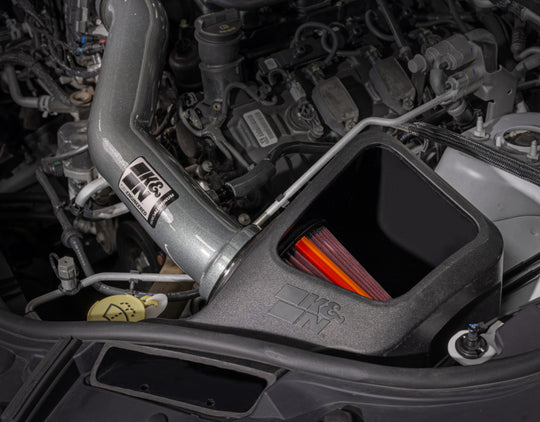 K&N Engineering aluminum cold air intake for 2016-2022 Jeep Grand Cherokee NextGen, showing the sleek intake pipe and filter.