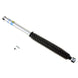 Bilstein 5125 Series lifted truck shock absorber showing black coil spring and metal body for off-road vehicle suspension.