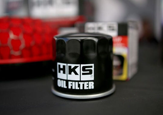 HKS oil filter 68-H65 UNF type 6 showing the filter with brand markings and metal body, designed for engine oil filtration.