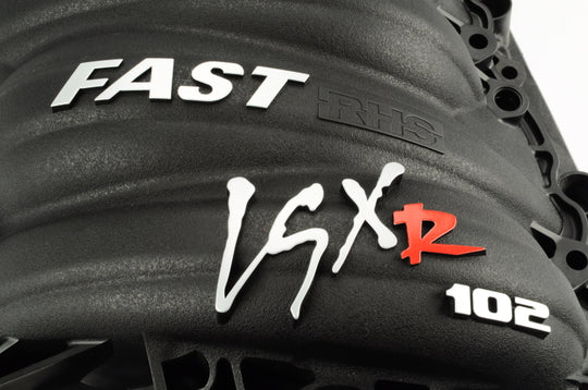 FAST LSXR 102mm Race Runner Intake Manifold, black aluminum with smooth finish and mounting ports for high-performance engine intake.