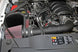 K&N Engineering cold air intake kit installed in a 2014-2015 Chevy/GMC 1500 V-8 5.3/6.2L engine, showcasing the performance air filter and tubing.