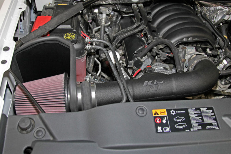 K&N Engineering cold air intake kit installed in a 2014-2015 Chevy/GMC 1500 V-8 5.3/6.2L engine, showcasing the performance air filter and tubing.